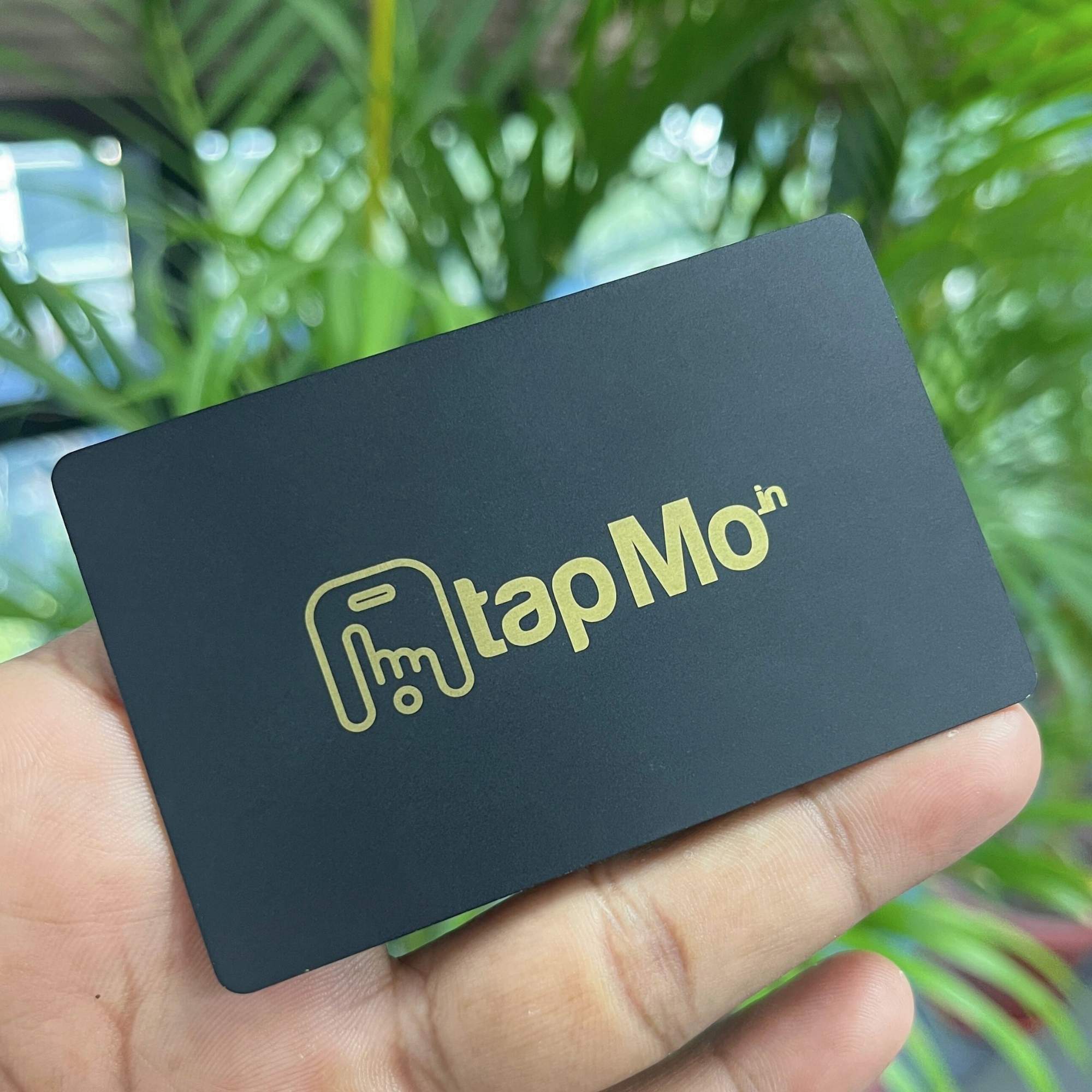 TapMo gold metal NFC business card shown in hand